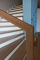 Лестница и ламинат в интерьере дизайнера Максима Ширванова. Ламинат BerryAlloc наименование Natural Oak 2st. Зашивка бетонного основания ясенем с ограждением из каленого стекла.